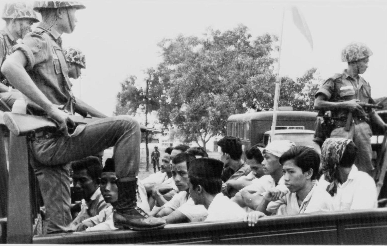 Under the Suharto-led regime from 1965 to 1966, many Communist Party members and leftists were persecuted, resulting in hundreds of thousands of massacres. Here members of the party are being transported to a prison in the capital, Jakarta (Photograph: [NTB Scanpix] Norwegian Refugee Council, 2015).