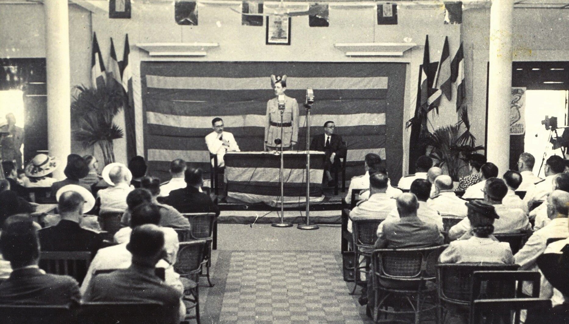De Gaulle giving a speech at the Brazzaville Conference (1944). On stage, from left to right, Rene Pleven, General De Gaulle, Felix Eboue (Photo: Musee Alexandre-Franconie, 2024). This photo is taken from the website of the Alexandre-Franconie Museum - Guyana Regional Collective.