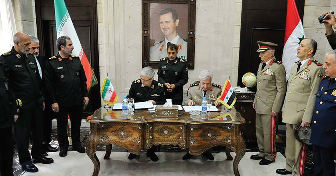 The visiting Irenian Chief of Staff Major General Mohammad Bagheri and Syrian Defense Minister Ali Abdullah Ayyoub sign a "ccomprehensive" military agreement at the Defense Ministry in the capital Damascus, on July 8, 2020. (Ammar Safarjalani/Xinhua)